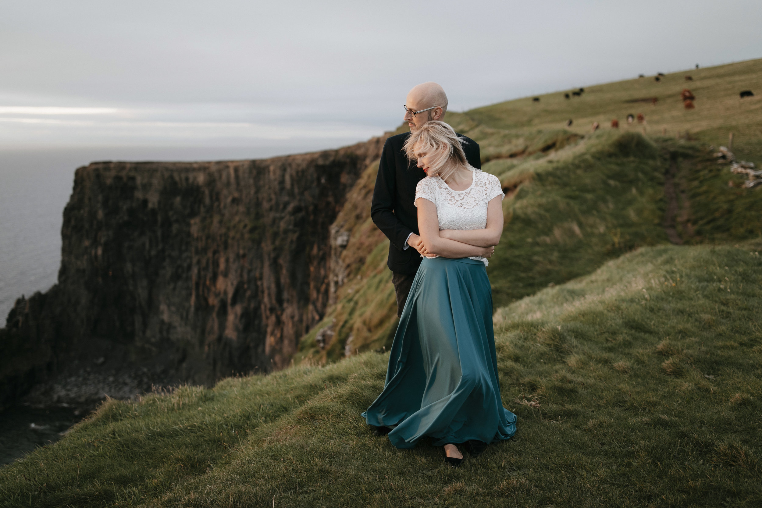 Romantic adventure engagement photography session at Cliffs of Moher by adventure elopement photographer colby and jess