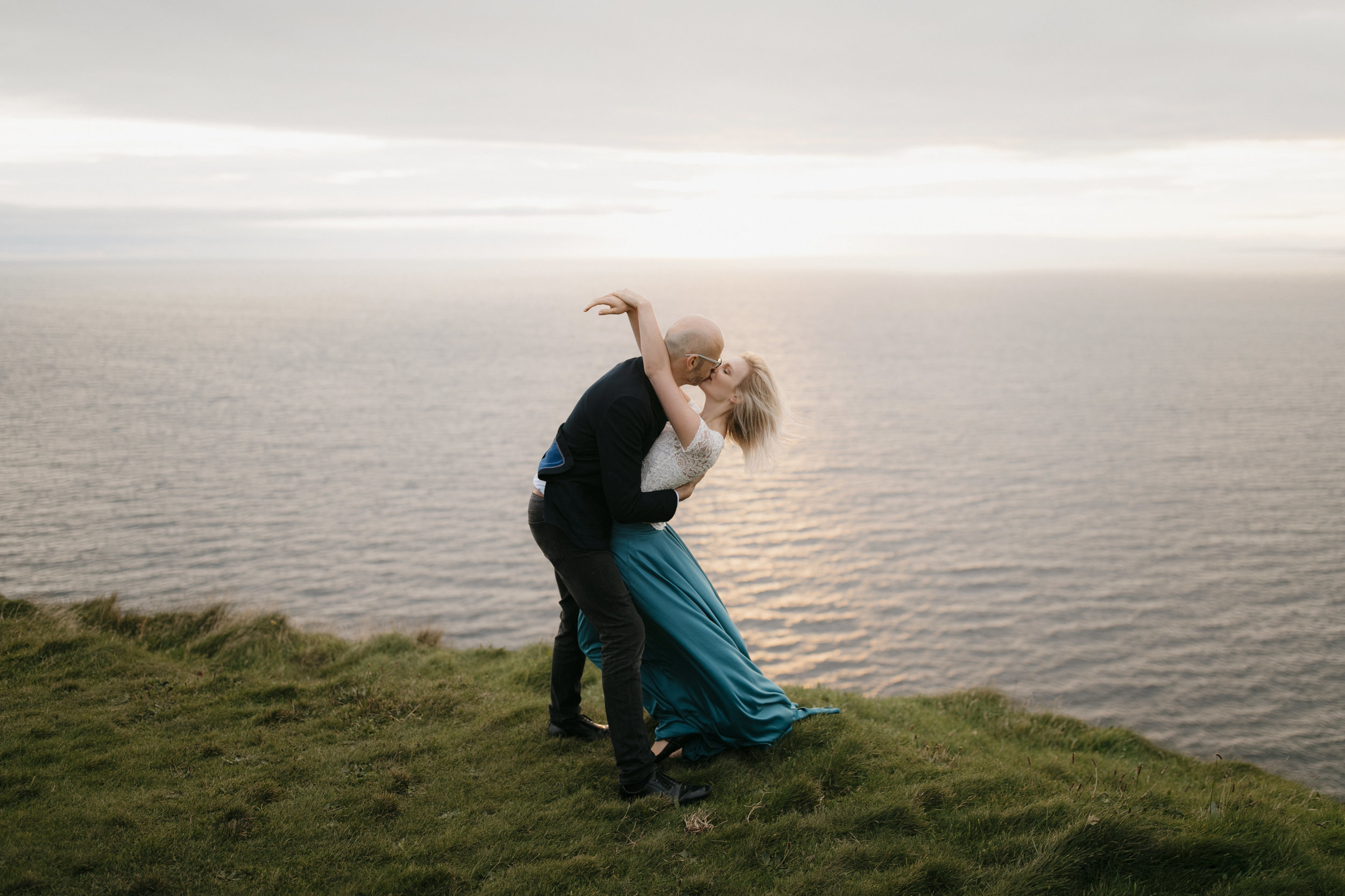 a romantic kiss at cliffs of moher by adventure elopement photographers colby and jess