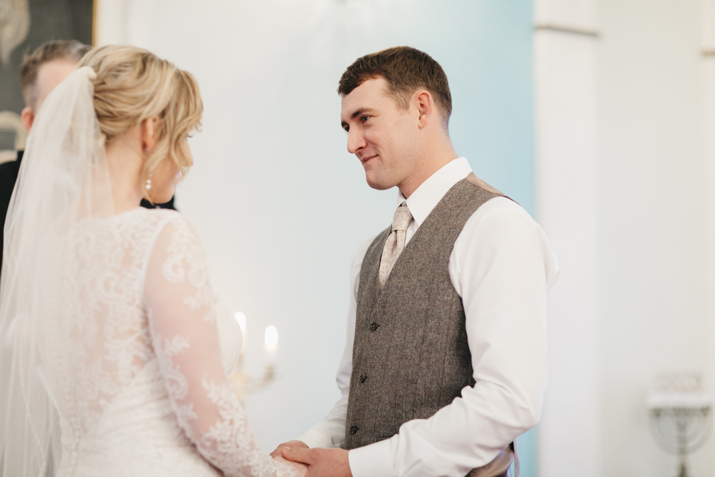 A lovely couple exchanges vows in Hvalsneskirkja Church during their Iceland Elopement Ceremony with photography by Colby and Jess.