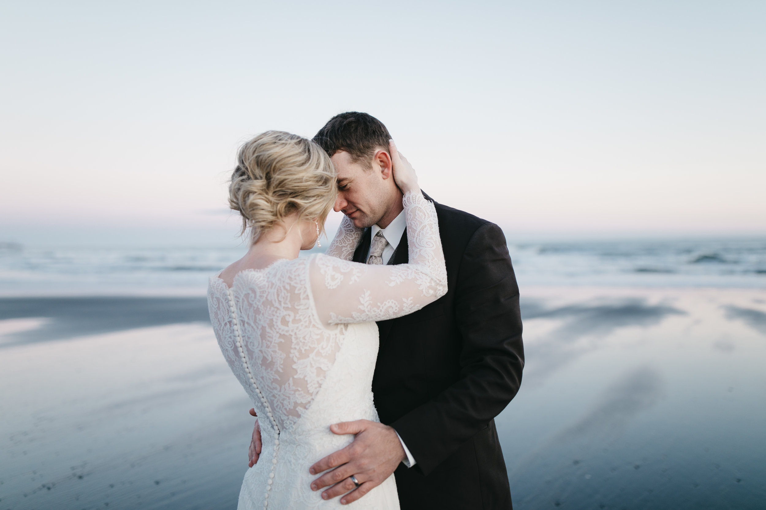 The sun sets on black sand beach during an Iceland Elopement Photography session by Colby and Jess.