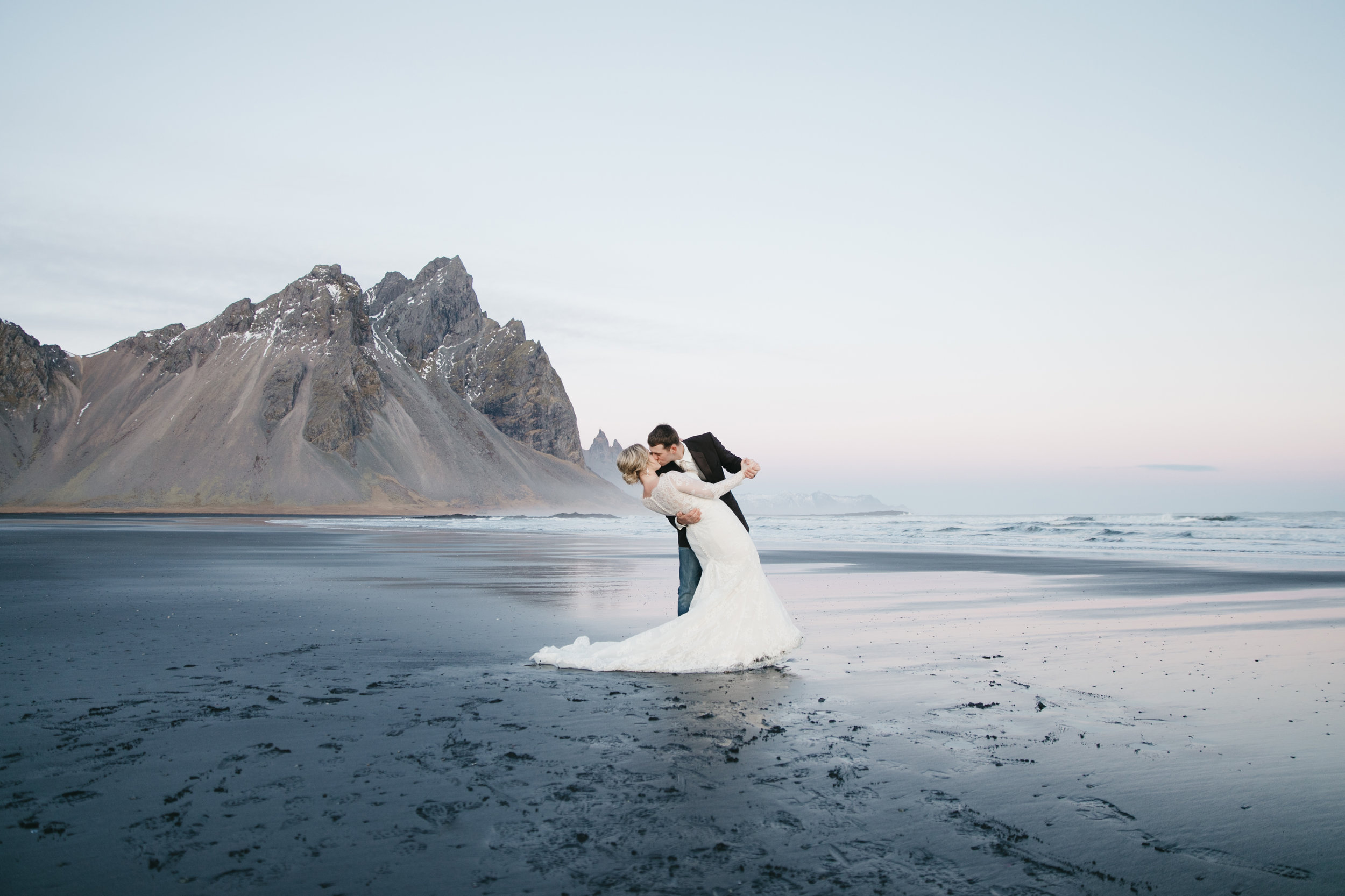 A bride and groom kiss during their Iceland Elopement Photography session in Vestrahorn with Iceland Destination Wedding photographers colby and jess.