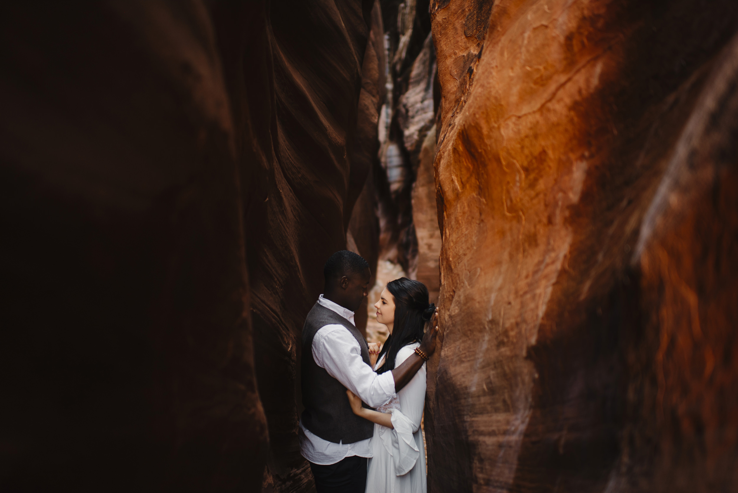 A couple looks into each others eyes during their Antelope Canyon Adventure Engagement Photography Session with Utah Destination Elopement Photographer Colby and Jess