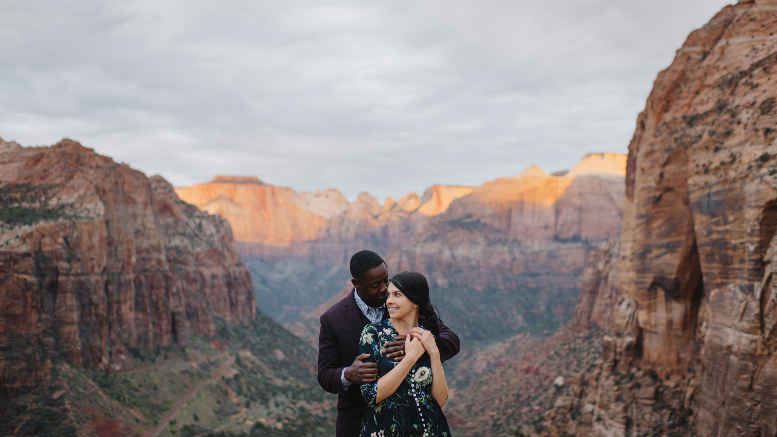 A man holds his wife during their Angels Landing Zion Engagement Photography Session with Zion National Park Elopement Photographer Colby and Jess