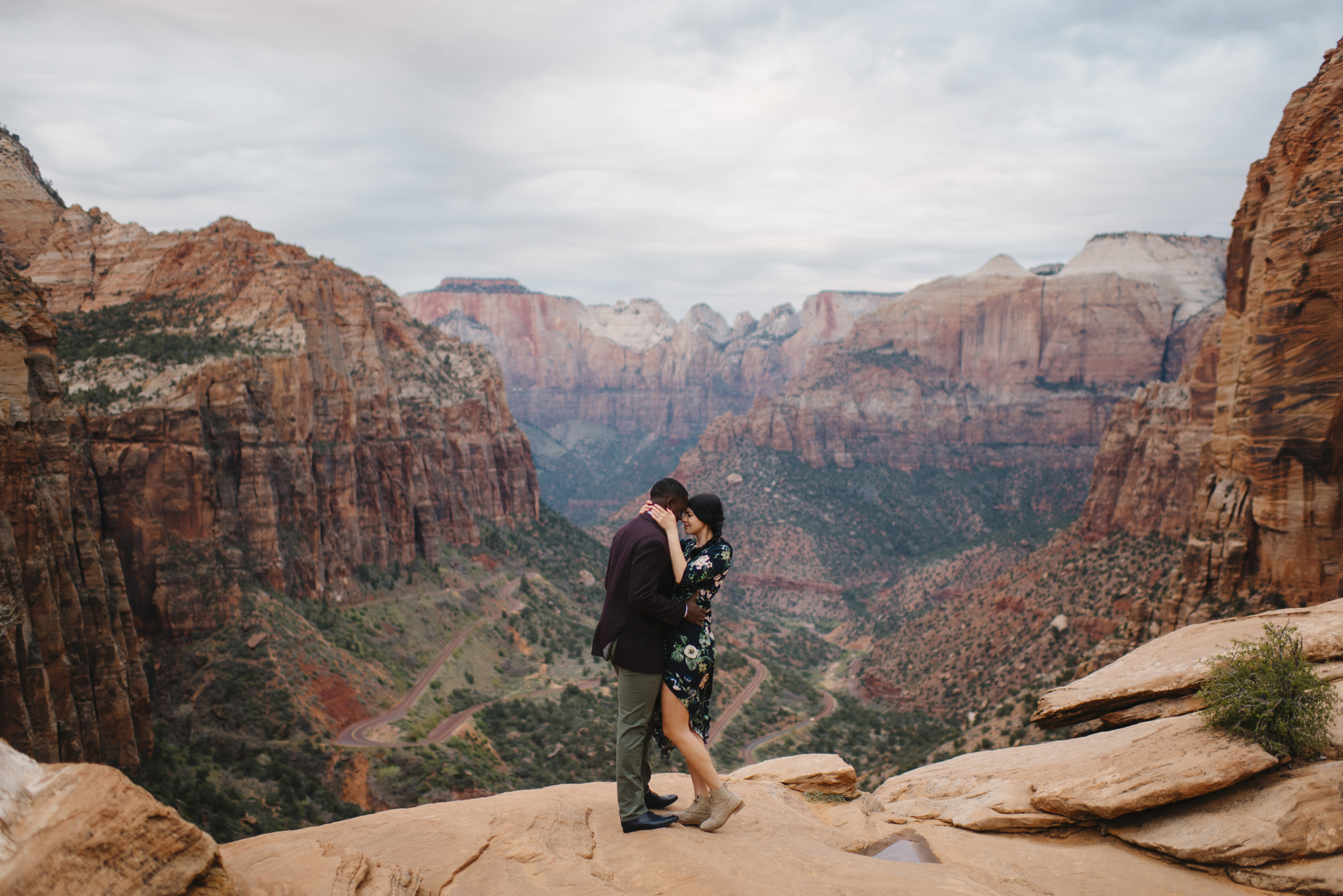A couple hug each other during their Angels Landing Zion Engagement Photography Session by Zion National Park Elopement Photographer Colby and Jess