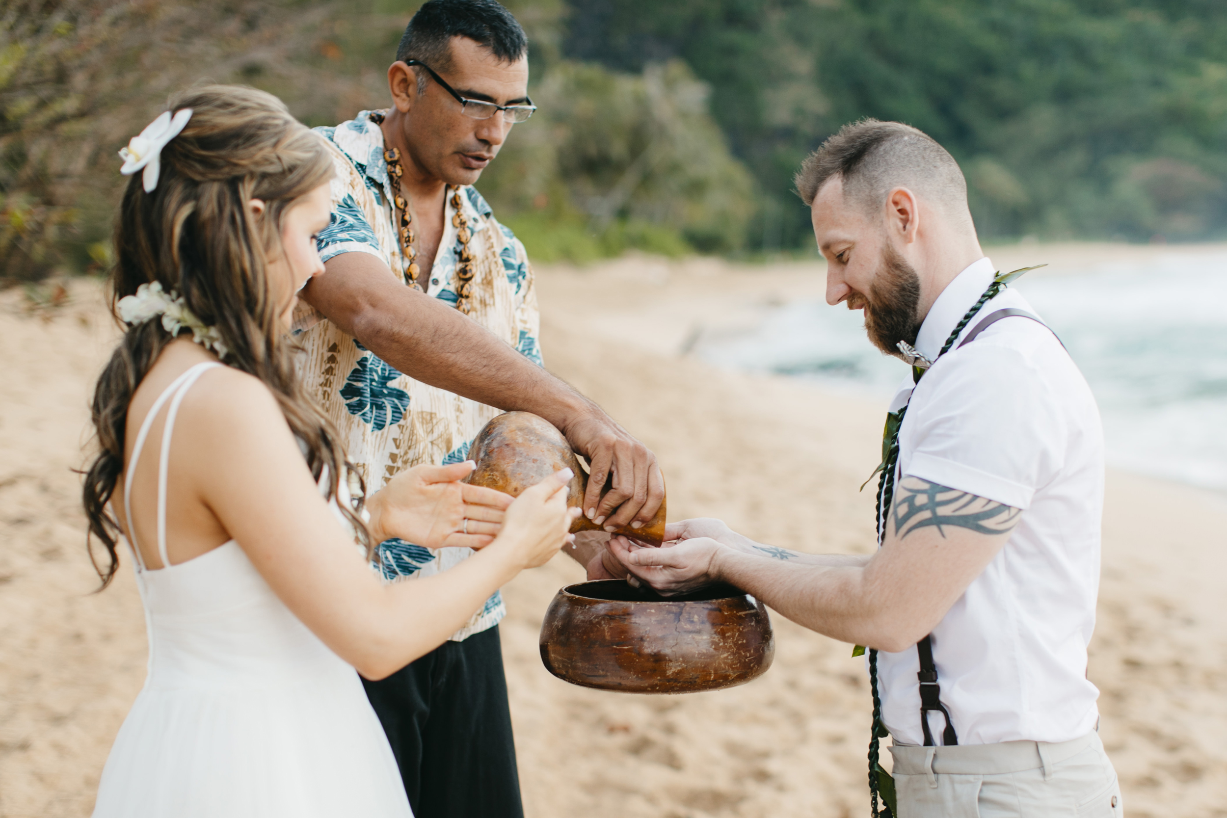 Wedding Ceremony at Tunnels Beach with Kauai Adventure Elopement photographers Colby and Jess