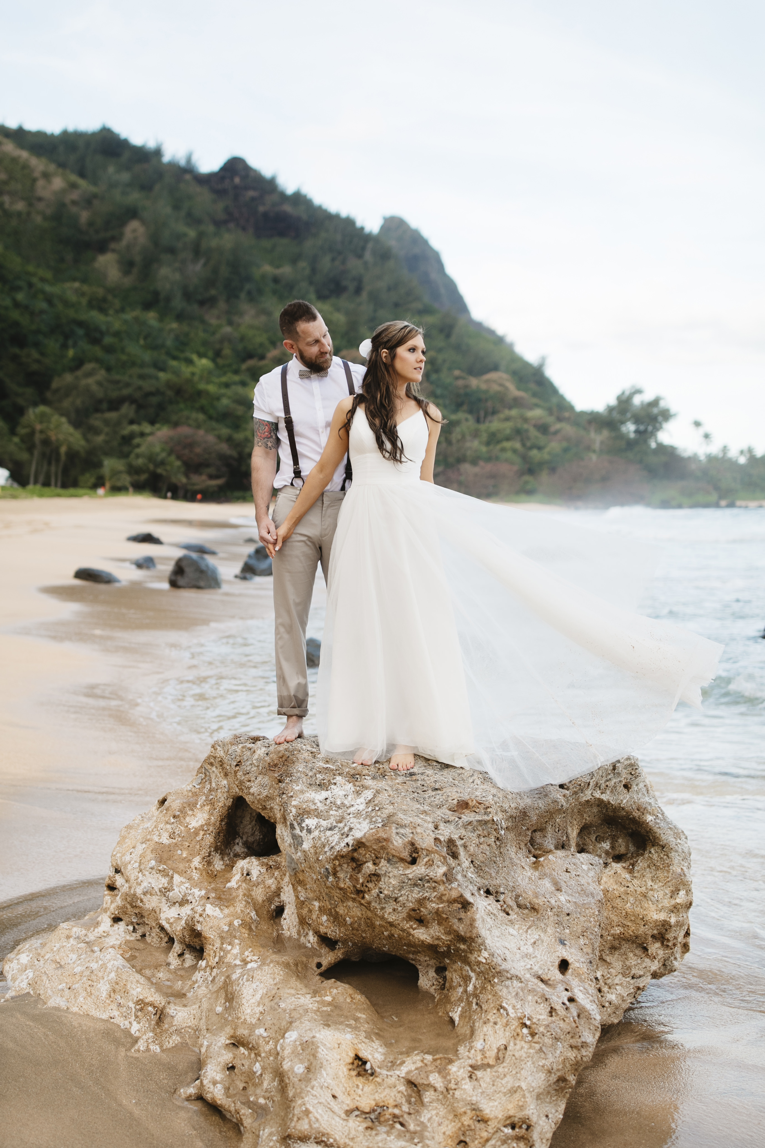A bride and groom after their Tunnels beach wedding ceremony with Kauai Elopement Photographers Colby and Jess