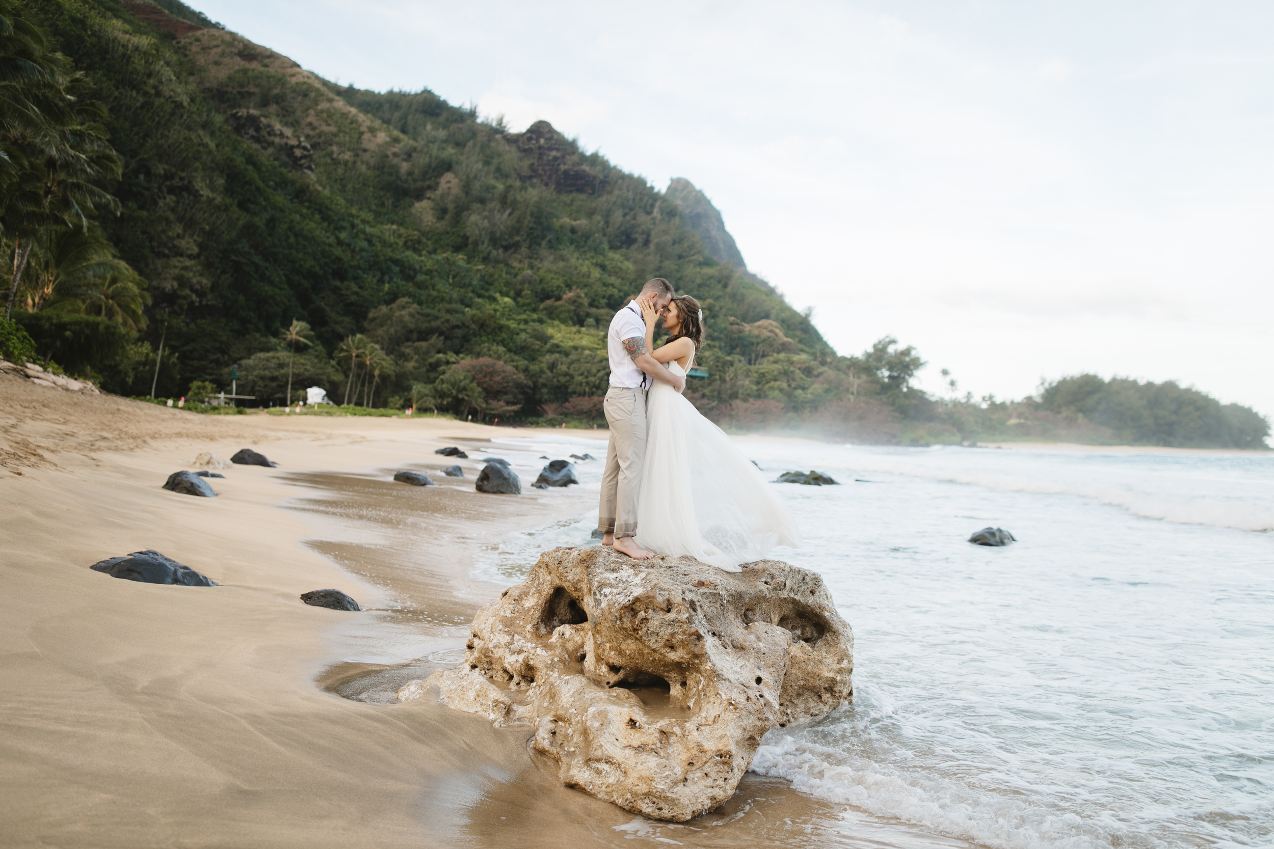 A bride and groom after their Tunnels beach wedding ceremony with Kauai Elopement Photographers Colby and Jess