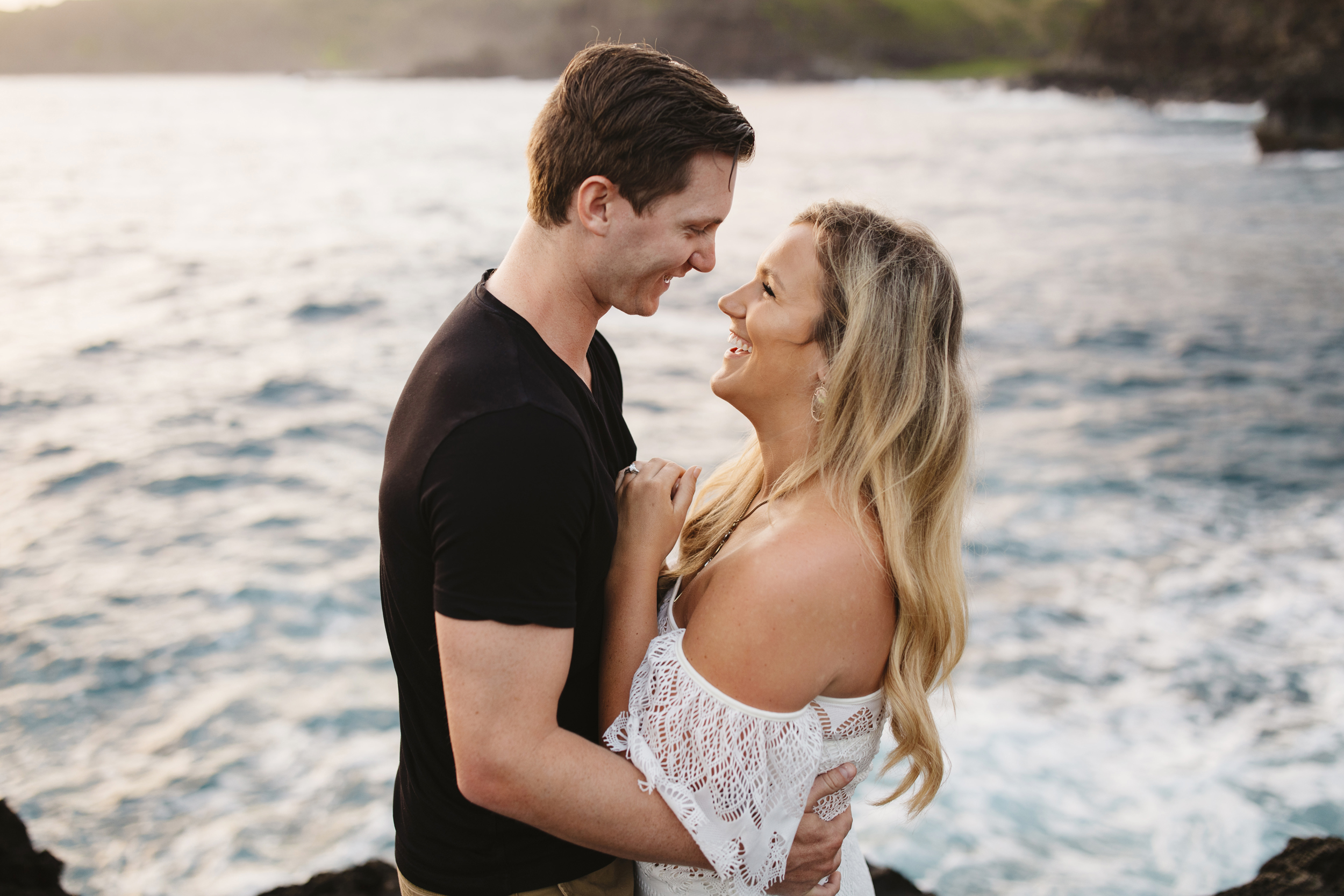 A lovely couple laughs during their adventure engagement session by Maui elopement Photographer Colby and Jess