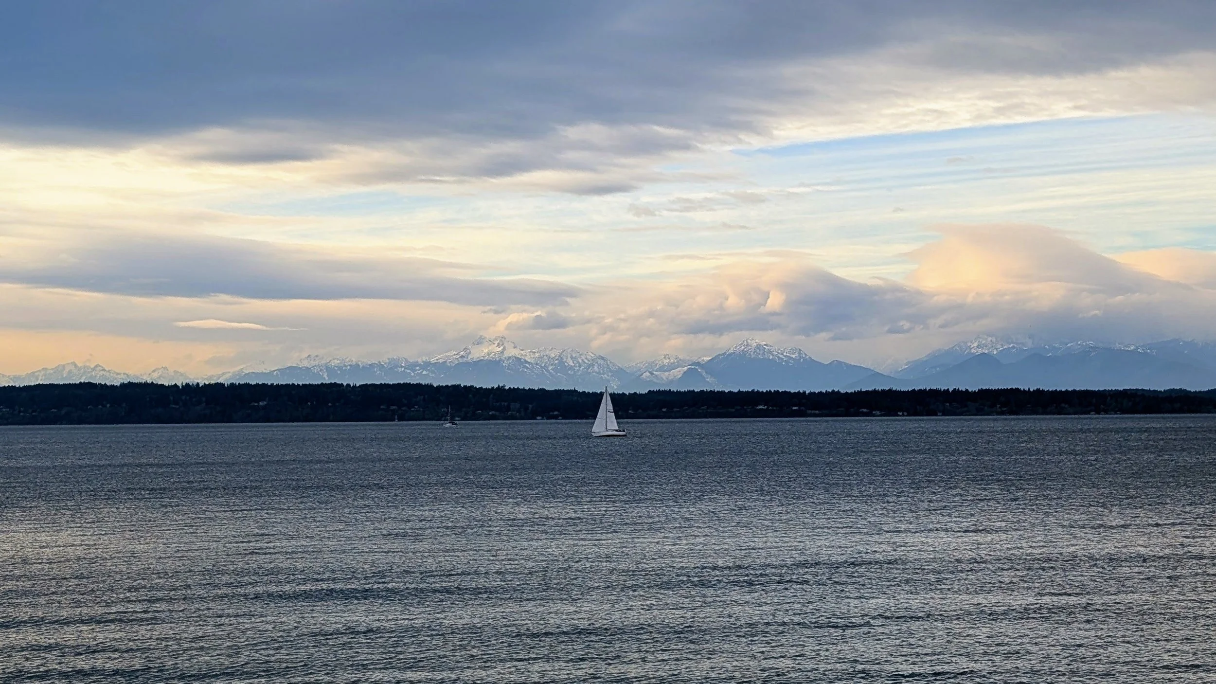 sailboat on Puget Sound with the Olympic Range in the background