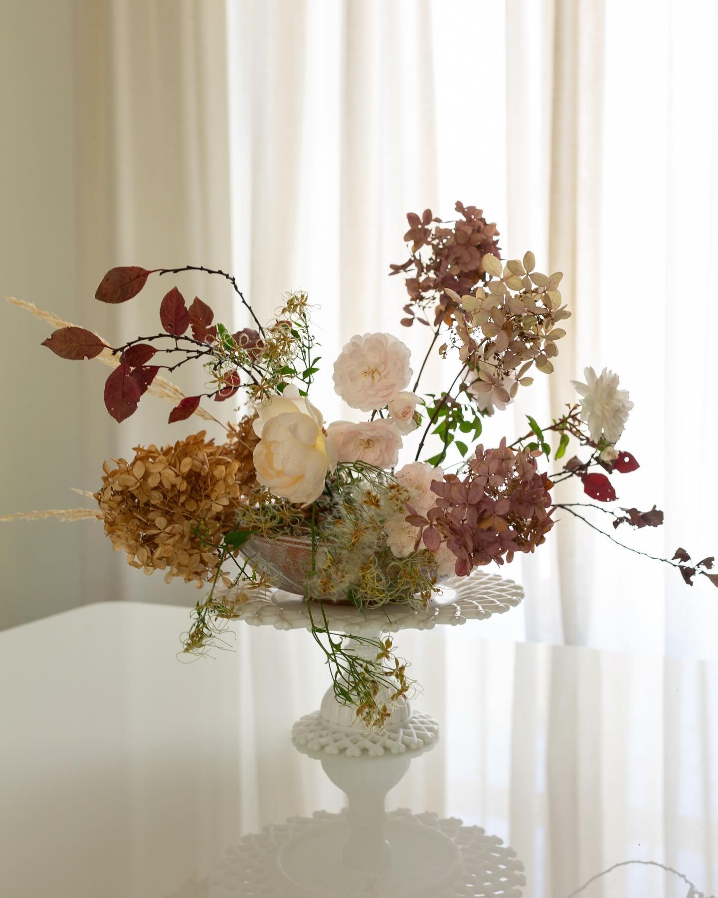 A November Floral Meditation:

The last of the roses - Au revoir!
A handful of dried Firelight hydrangeas - I overwatered them this year! 
A few grasses - Karl Foerster for the gold
and some fuzzy Sweet Autumn Clematis that went to seed - for the qui