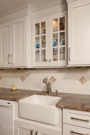 traditional kitchen design in Yardley, PA with farmhouse sink and glass door cabinets