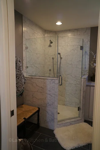 Bathroom design in Yardley, PA with Carrerra marble tiled, angled shower