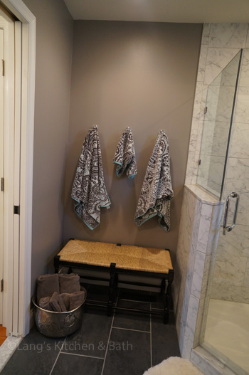 Bathroom design in Yardley, PA with seating area next to the shower
