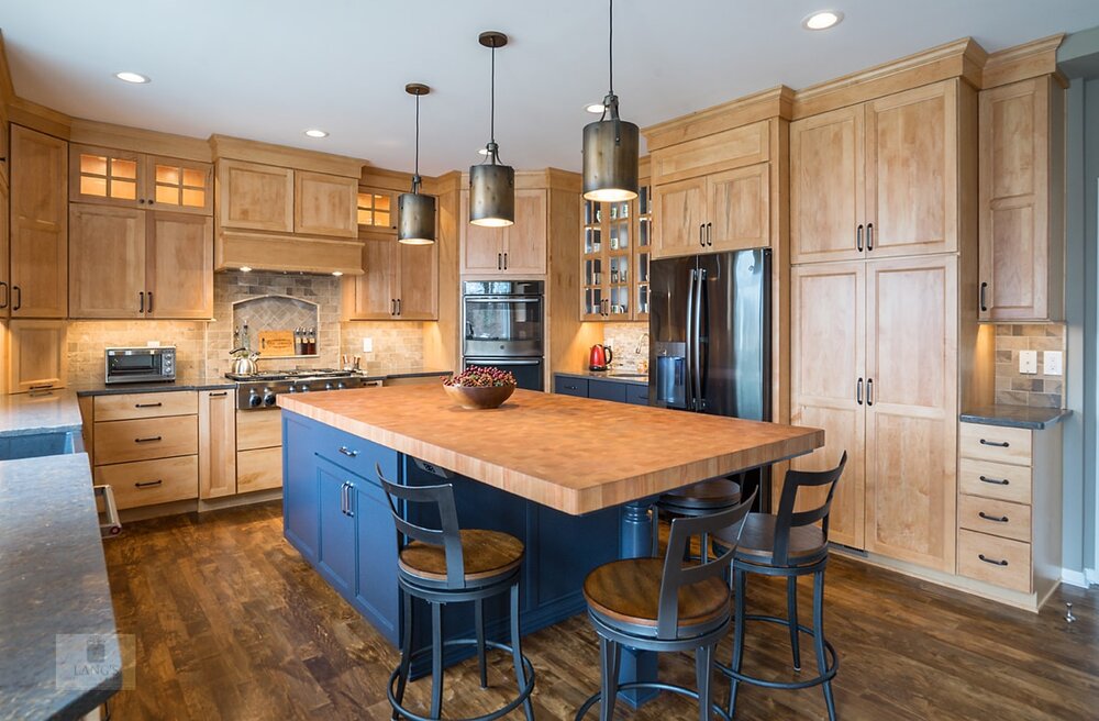 blue kitchen cabinets with wood countertop