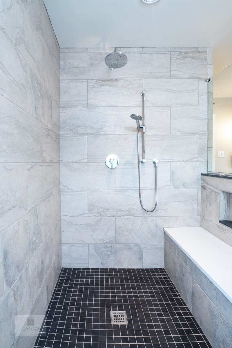 shower with tile floor and bench