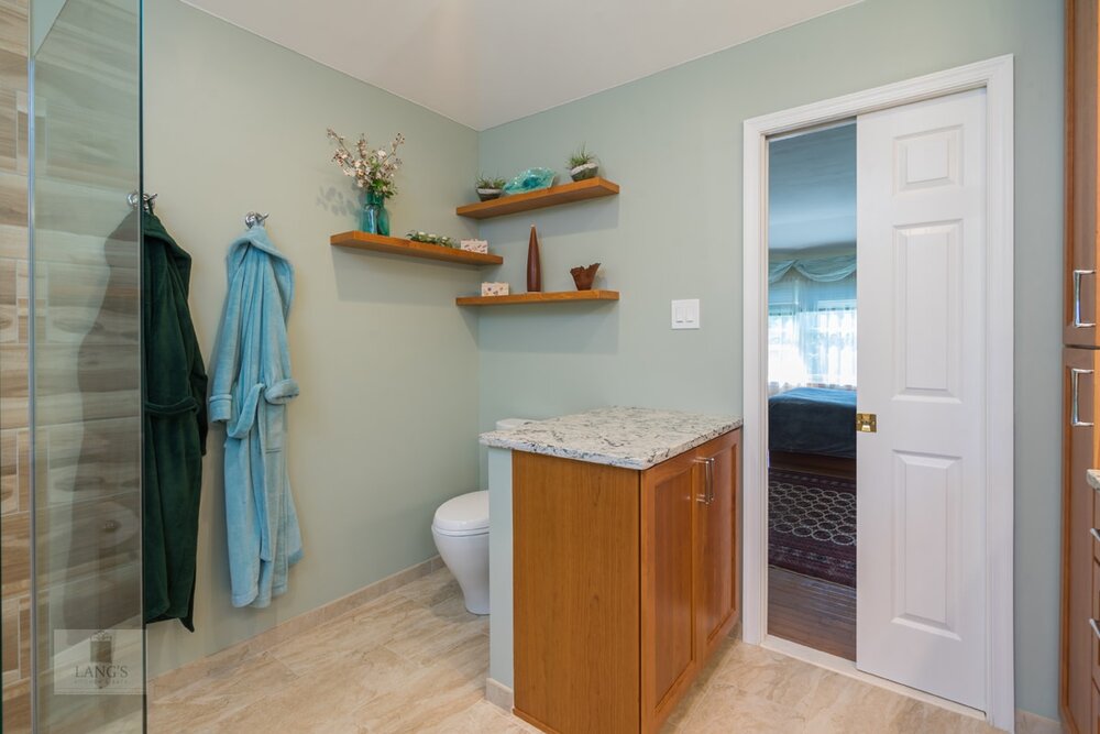 bathroom design with toilet and half privacy wall