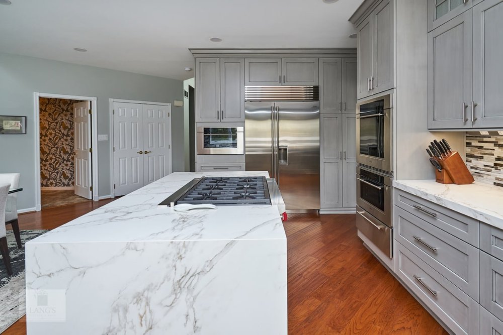 large kitchen design with waterfall island