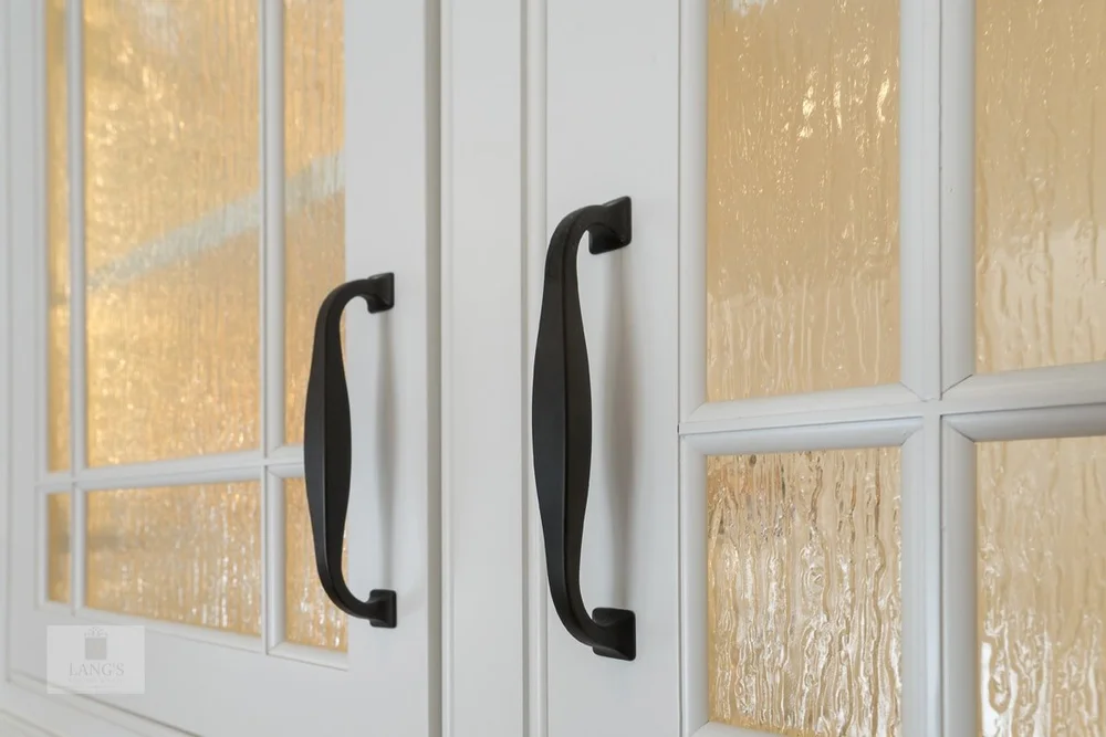 white kitchen cabinet with black pulls
