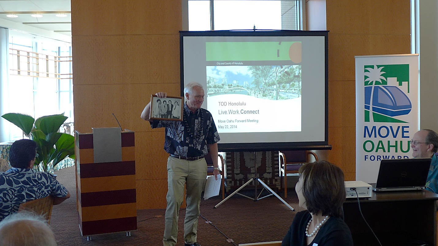 Mayor Kirk Caldwell holds up a photo given to him by Move Oahu Forward executive director Jennifer Sabas of his "younger days" when he was in Washington D.C.
