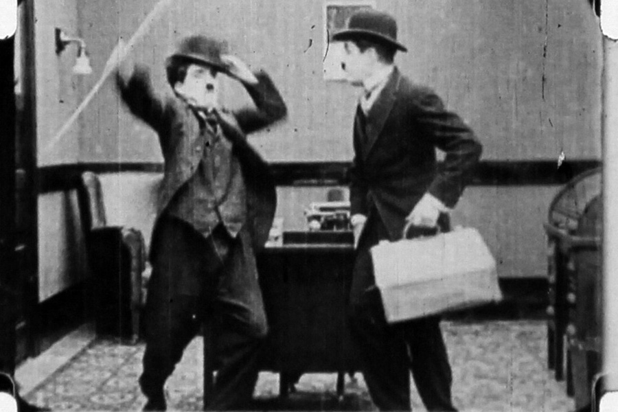  The frames show Chaplin (left) arguing with a look-alike in an office. 