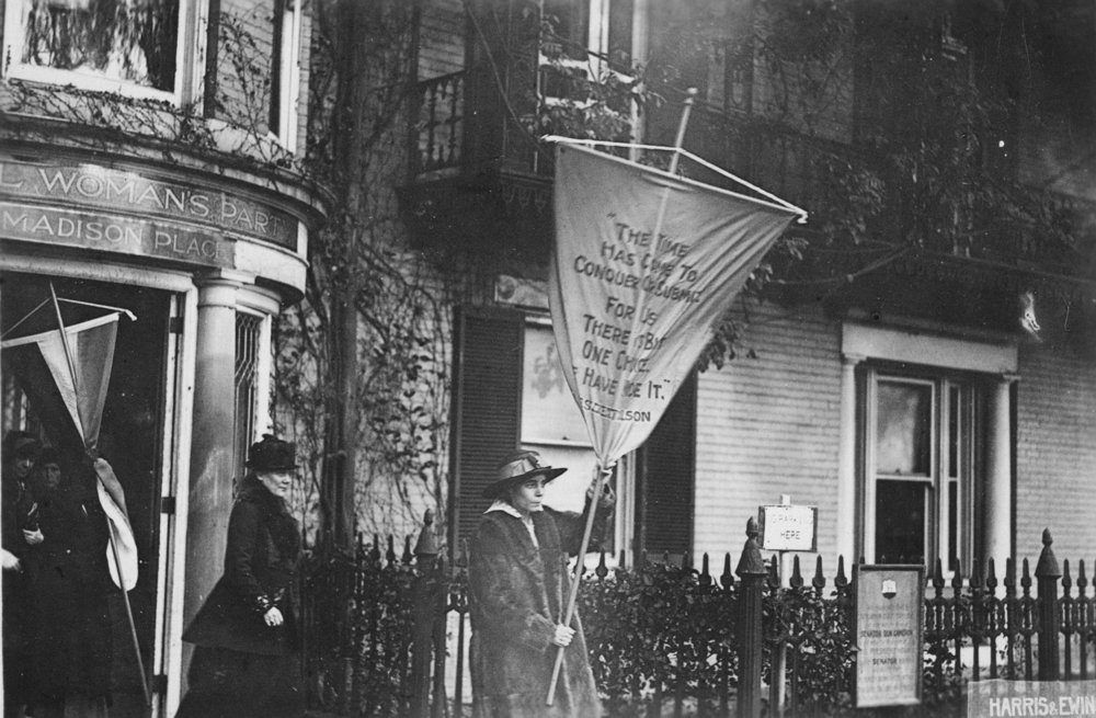  The day after the police announce that future pickets would be given limit of 6 mos. in prison, Alice Paul led picket line with banner reading "The time has come to conquer or submit for there is but one choice - we have made it." She is followed by