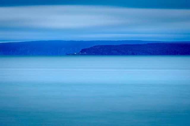 The New Brunswick coast from across the Bay of Fundy. I wanted to try playing with something very minimal with the haze, clouds and water all being very similar in tone. #hallsharbour #novascotia #longexposure #minimalism #fujifilm #fujifilmxt1