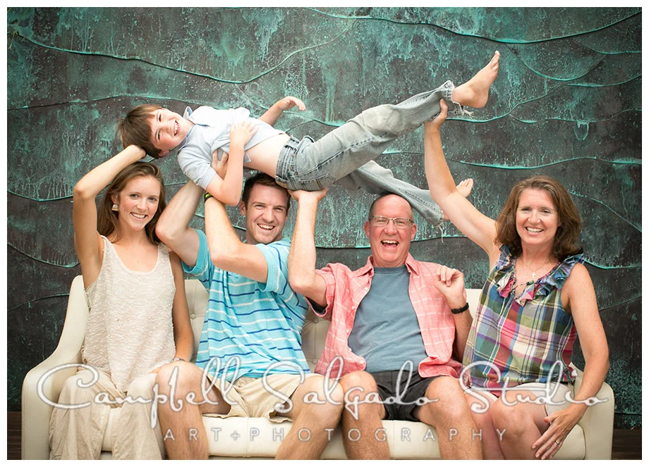 Portrait of family on white couch by Portland photographers Campbell and Salgado.