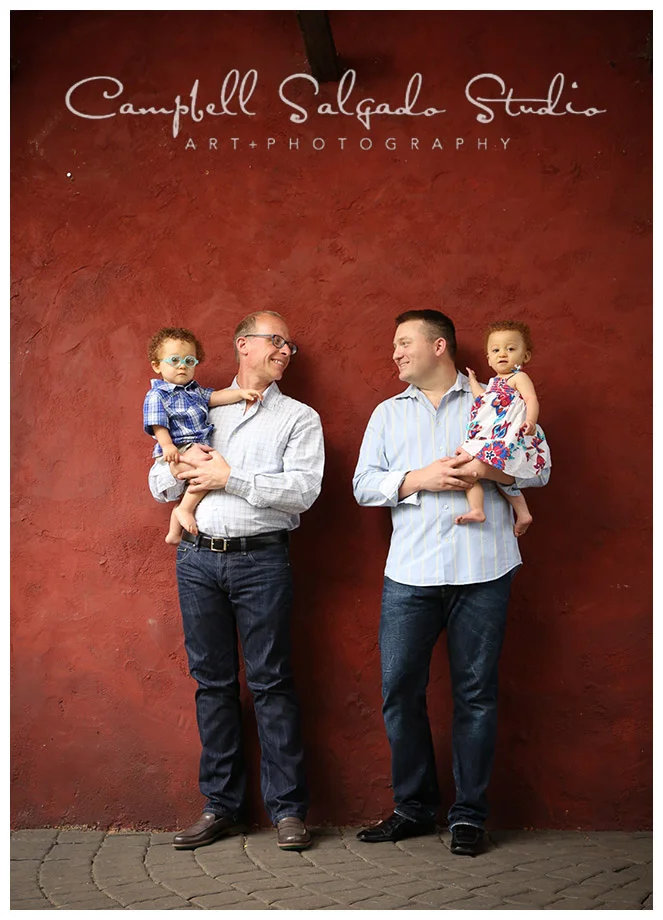 Portrait of family on red background in Portland, Oregon by Campbell Salgado Studio.