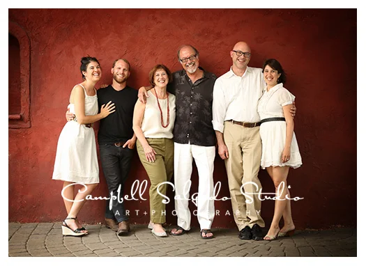 Family portrait photography in front of a red background at Campbell Salgado Studio in Portland, Oregon.