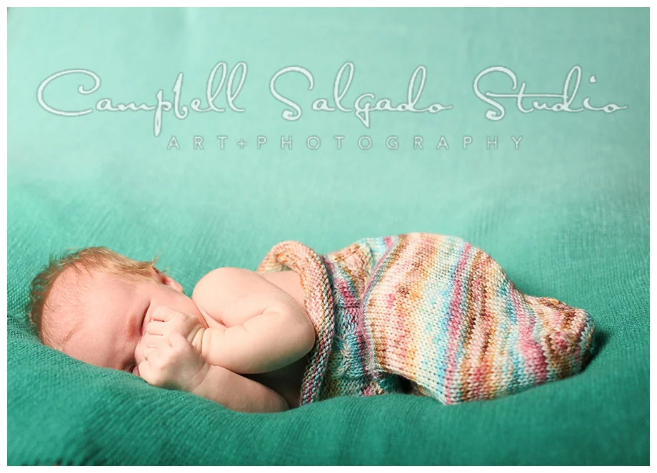 Portrait of infant on green hombre background at Campbell Salgado Studio.
