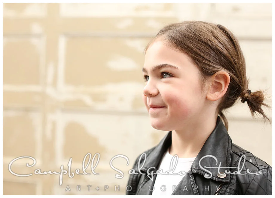Portrait of young girl on vintage doors background at Campbell Salgado Studio.