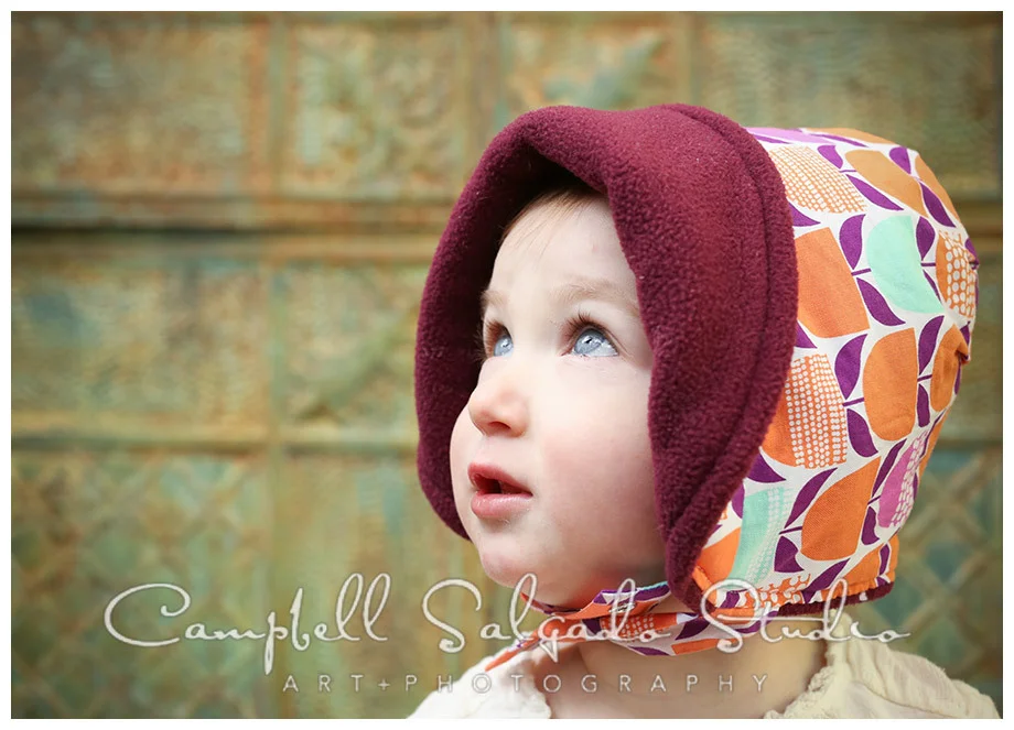Portrait of little girl on vintage tin background at Campbell Salgado Studio.
