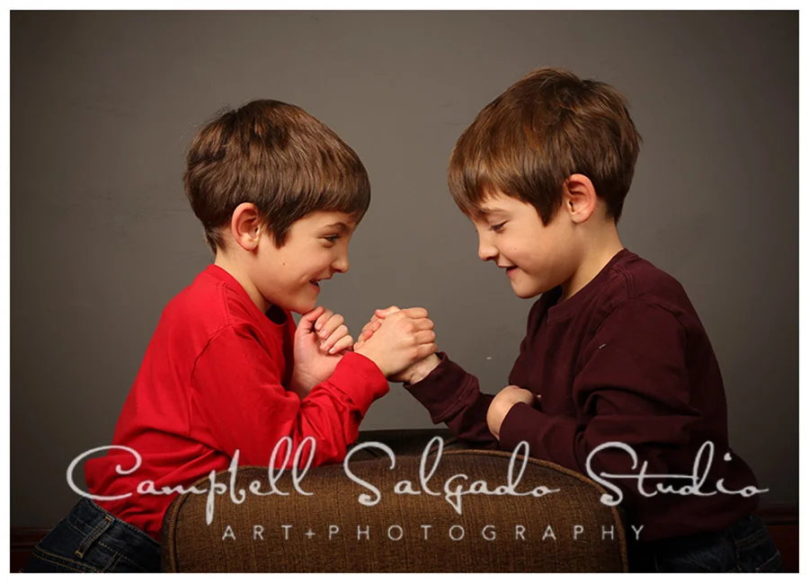 Portrait of twin boys on grey background at Campbell Salgado Studio.