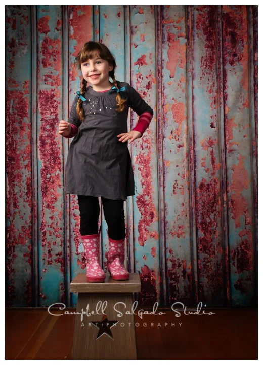Portrait of young girl on Italian metal background by children's photographers at Campbell Salgado Studio.