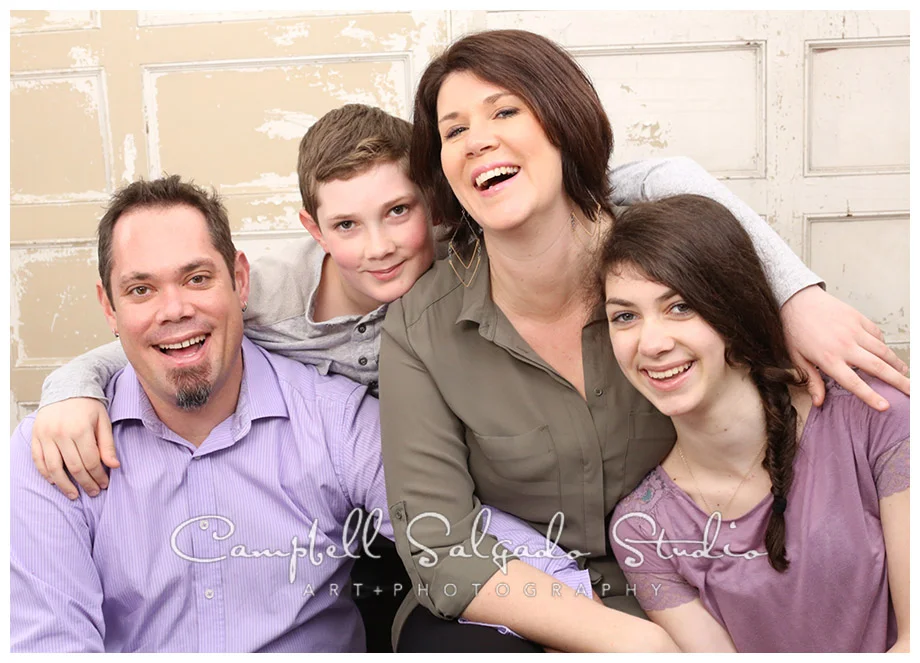 Portrait of family on vintage doors background at Campbell Salgado Studio.