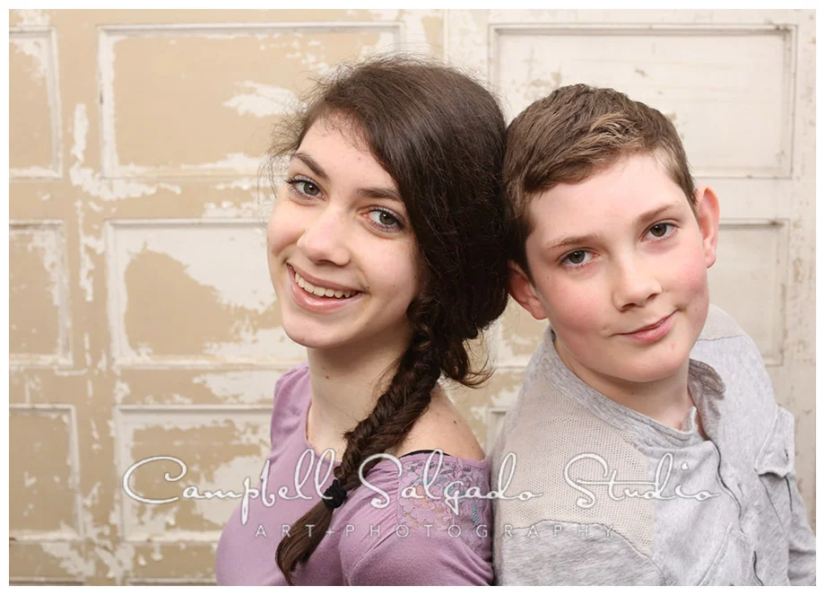 Portrait of siblings on vintage doors background at Campbell Salgado Studio.