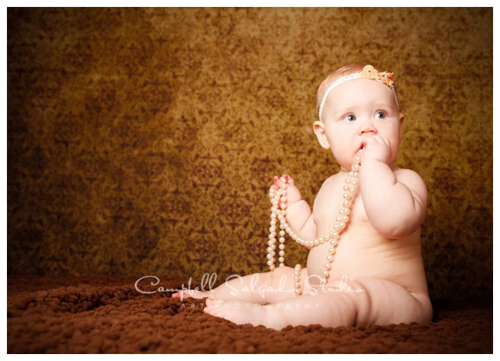 Portrait of baby girl on vintage amber background at Campbell Salgado Studio.