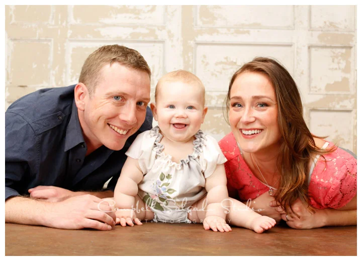 Portrait of family on vintage French doors background at Campbell Salgado Studio.