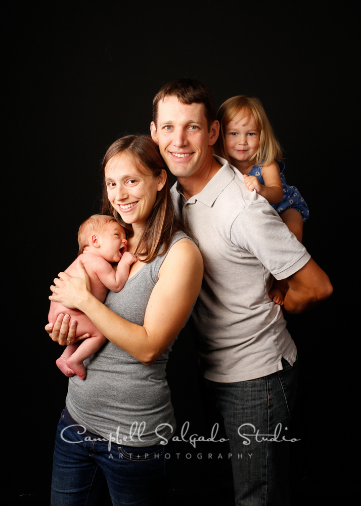  Portrait of family on black background by family photographers at Campbell Salgado Studio, Portland, Oregon. 