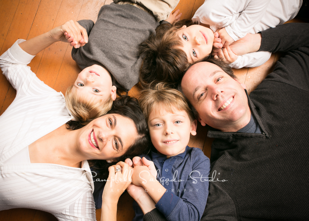  Portrait of family on pine floor&nbsp;by family photographers at Campbell Salgado Studio, Portland, Oregon. 