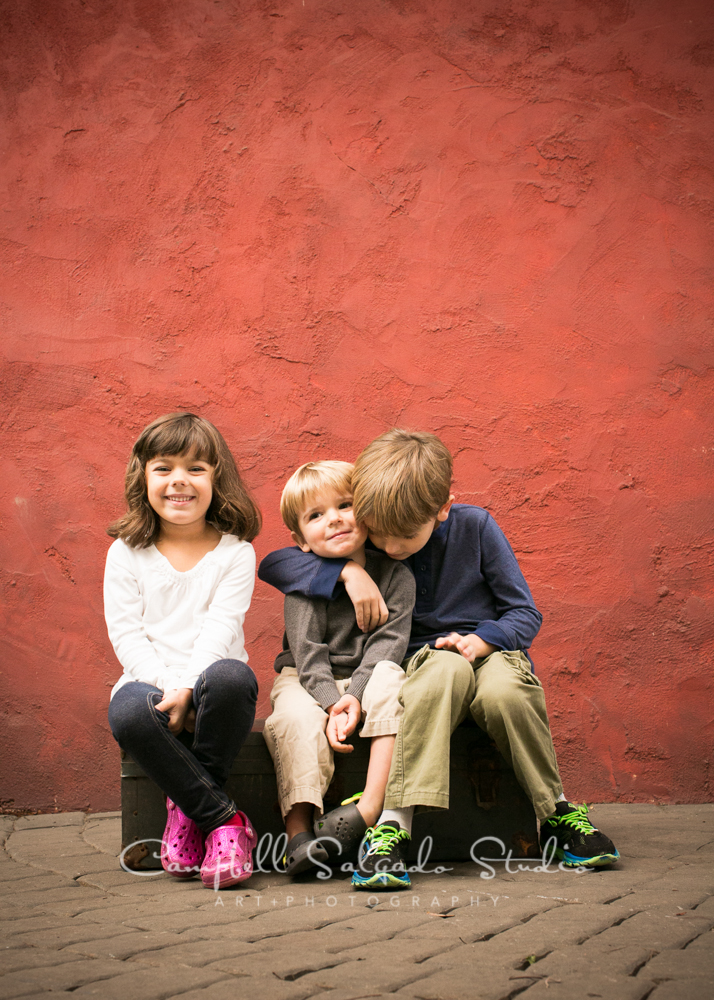  Portrait of children on red stucco background&nbsp;by children's photographers at Campbell Salgado Studio, Portland, Oregon. 