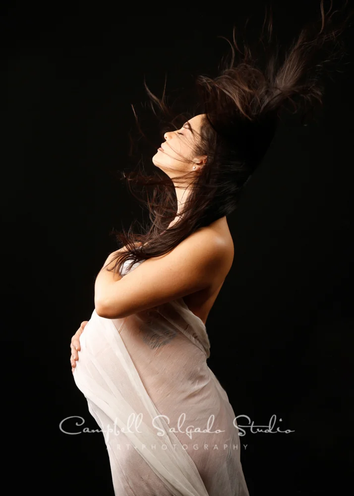 Pregnancy portrait of woman on black background by maternity photographers at Campbell Salgado Studio, Portland, Oregon.