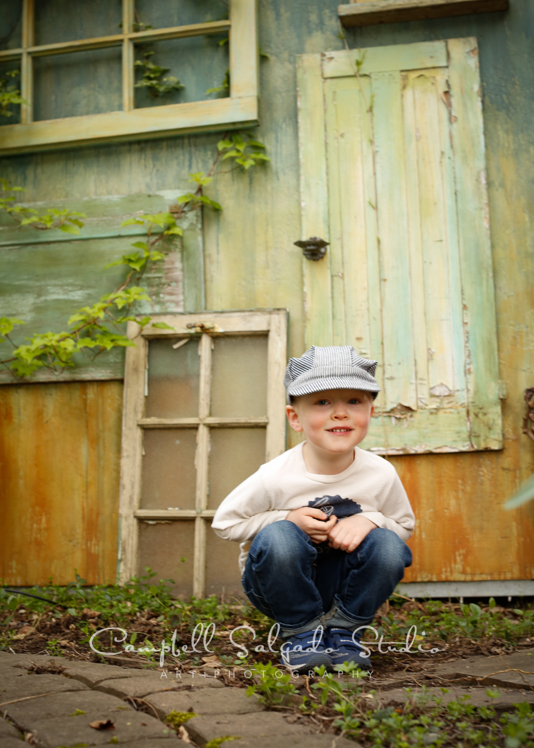  Portrait of child on vintage green doors background&nbsp;by childrens photographers at Campbell Salgado Studio, Portland, Oregon. 