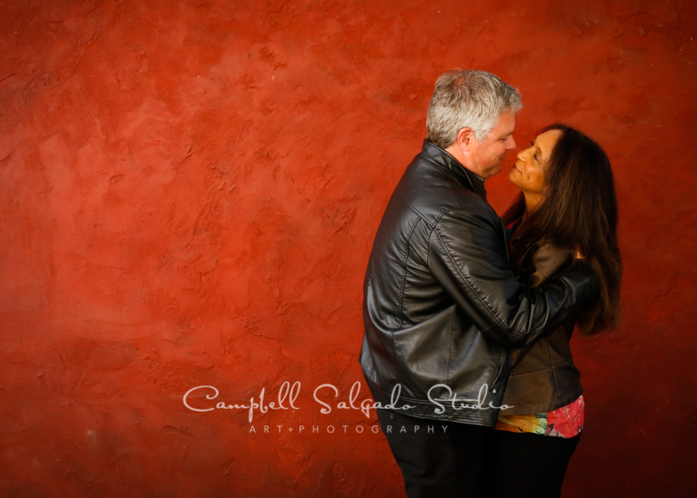  Portrait of couple on red stucco background&nbsp;by couples&nbsp;photographers at Campbell Salgado Studio, Portland, Oregon. 