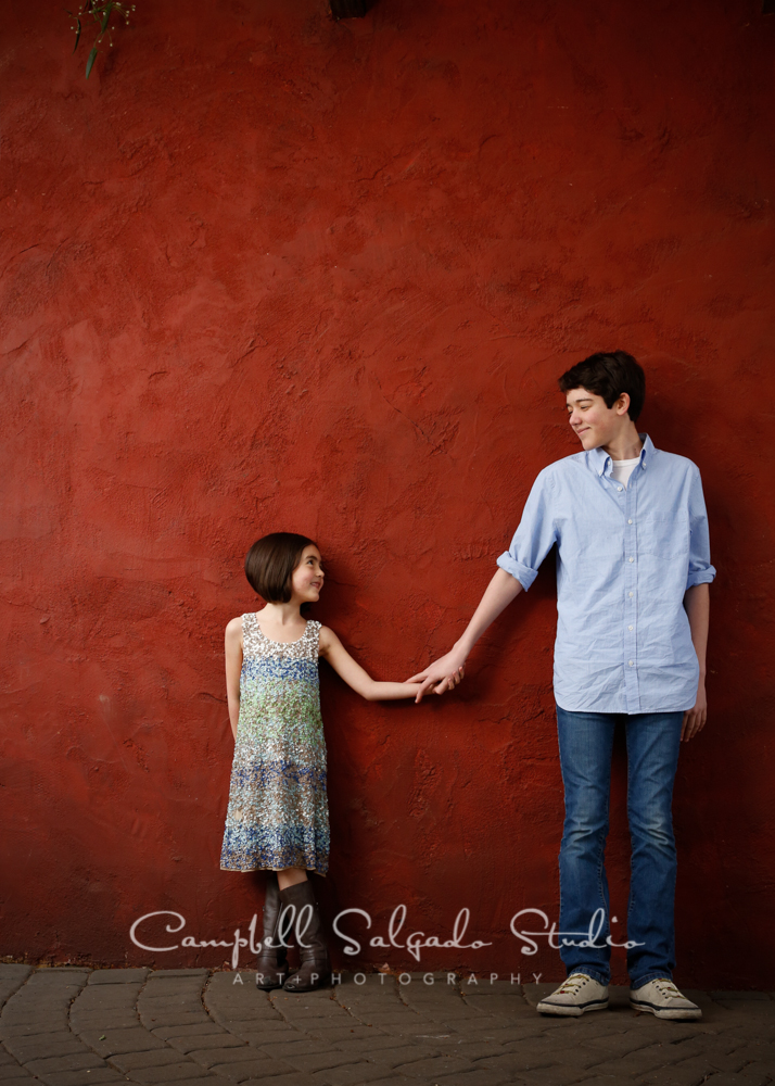  Portrait of children on red stucco background&nbsp;by family photographers at Campbell Salgado Studio, Portland, Oregon. 