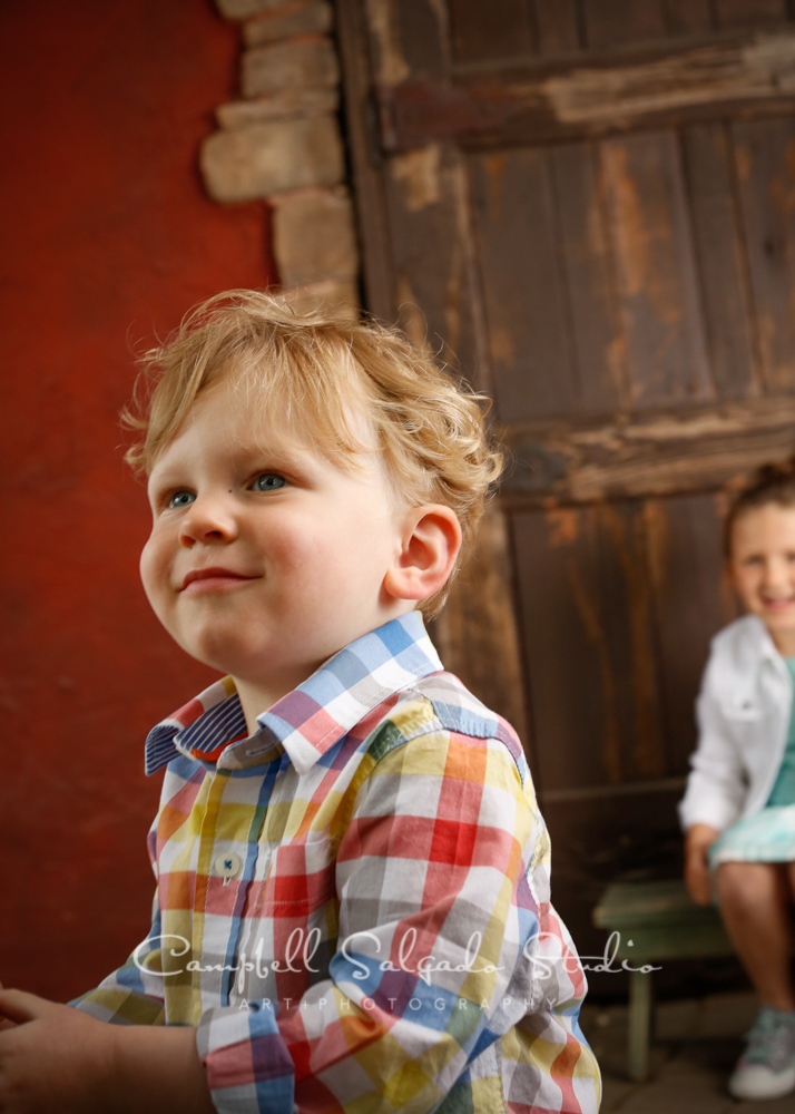  Portrait of boy&nbsp;on rustic door&nbsp;background&nbsp;by child&nbsp;photographers at Campbell Salgado Studio, Portland, Oregon 