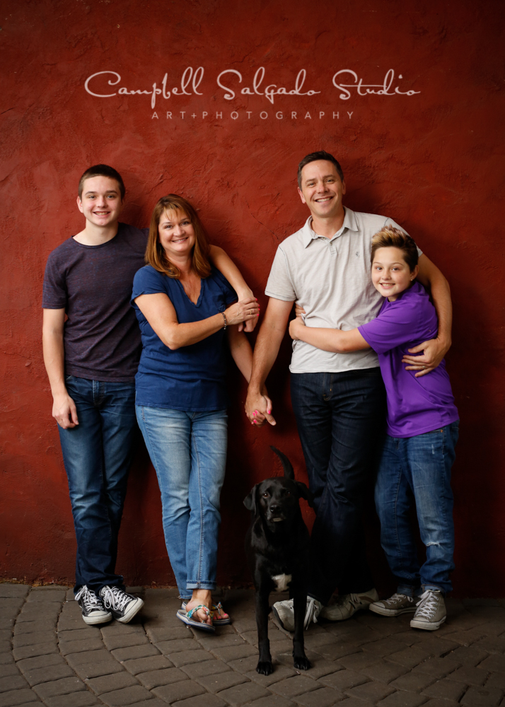  Portrait of family on red stucco background&nbsp;by family photographers at Campbell Salgado Studio, Portland, Oregon. 