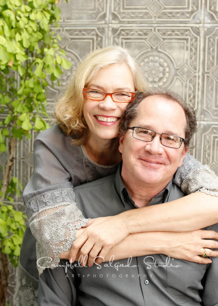  Portrait of couple&nbsp;on gray tiles&nbsp;background&nbsp;by family photographers at Campbell Salgado Studio, Portland, Oregon. 