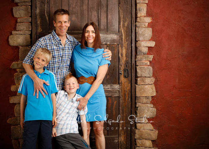  Portrait of family on rustic door background&nbsp;by family photographers at Campbell Salgado Studio, Portland, Oregon. 