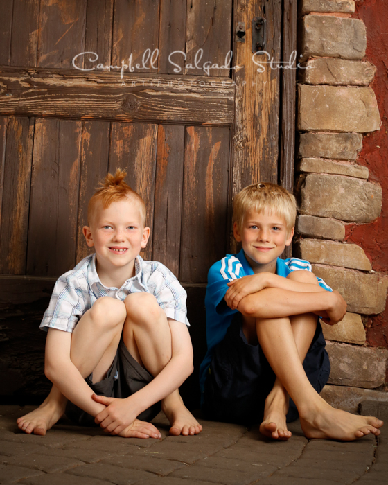  Portrait of brothers on rustic door&nbsp;background&nbsp;by family photographers at Campbell Salgado Studio, Portland, Oregon. 